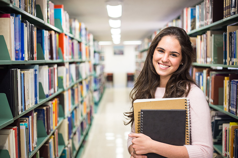 image of a girl in the library smiling